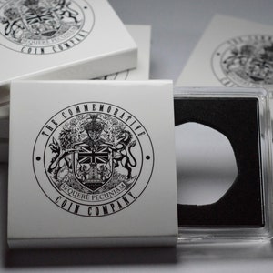 May include: A white coin case with a black and white logo that says "The Commemorative Coin Company" and a black and white crest with the words "Sequere Pecuniam". The case is open and a clear plastic coin holder is visible.