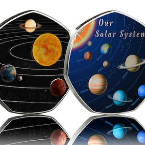 May include: Two silver coins with a depiction of our solar system. One coin has a black background with the sun and planets in their orbits. The other coin has a blue background with the planets and their names labeled.