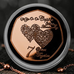 May include: A heptagonal copper-coloured commemorative coin featuring two ornate heart designs and the engraved text: For You On Our Copper Wedding Anniversary, 7 Years Together. The coin is encased in a clear circular protective capsule.