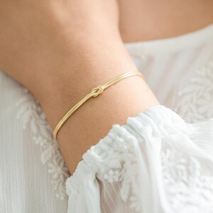 A model wearing a Gold Plated Sterling Silver Infinity Knot Personalised Bracelet