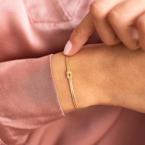 A model wearing a Gold Plated Sterling Silver Infinity Knot Personalised Bracelet