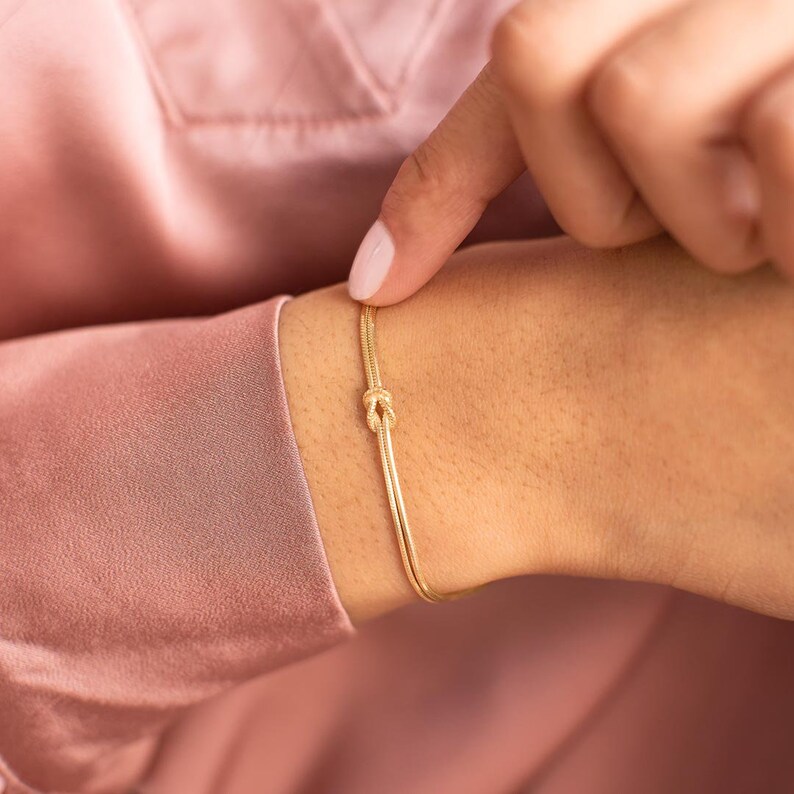 A model wearing a Gold Plated Sterling Silver Infinity Knot Personalised Bracelet