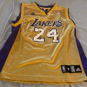 Kobe Bryant in vintage Lakers uniform pumps his fist.jpg