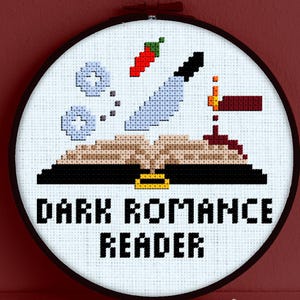 Può includere: Ricamo a punto croce circolare con la scritta "DARK ROMANCE READER". Il disegno comprende un libro, un coltello, un peperoncino e altri elementi. Il ricamo è in un cerchio nero, con sfondo bianco. Il testo "Snailfishes Stitches" è in basso.