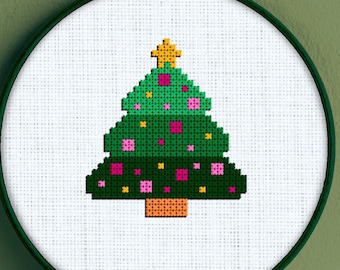 May include: A green, yellow, and pink pixelated Christmas tree cross-stitch pattern in a white embroidery hoop. The text "Snailfishes Stitches" is at the bottom of the image.