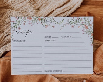 May include: A white recipe card with a floral border. The card has sections for ingredients, directions, serves, and cook time. It also has a space for "From the kitchen of".