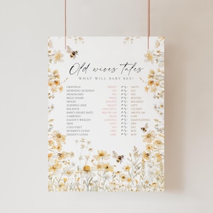 May include: A printable baby shower game with a floral background and a bee illustration. The game is titled "Old Wives Tales" and asks guests to guess the answers to various questions about the baby, such as whether the baby will be sweet or salty, have a wide or round belly, and be a boy or girl.