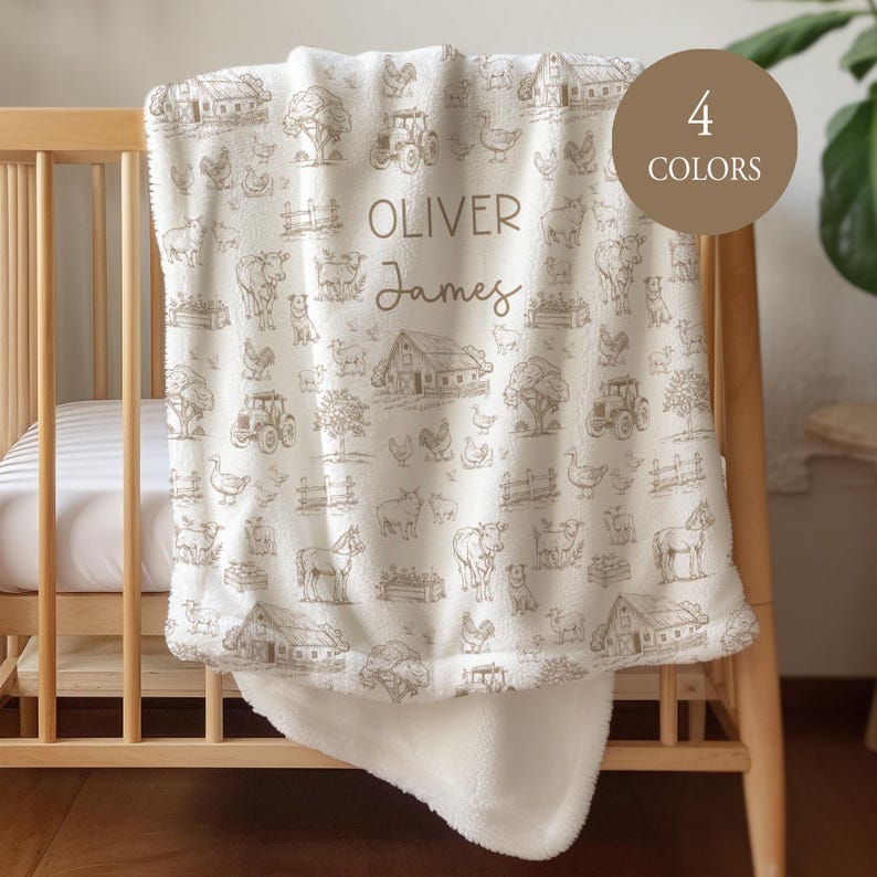 May include: A white fleece blanket featuring a repeating brown line-art pattern of farm animals, barns, tractors, and trees. The center is personalized with the names OLIVER and James in brown text. A circular badge reads 4 COLORS.
