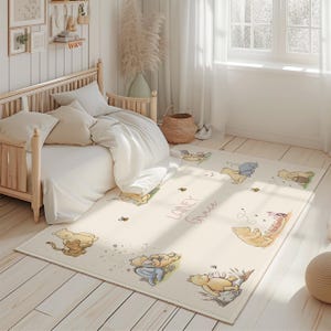 May include: An off-white rectangular rug with illustrations of Winnie the Pooh characters. The rug has the name "Lainey Grace" in cursive. The rug is in a child's bedroom with a wooden bed and white bedding.