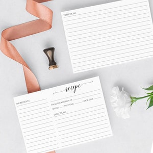 May include: Two blank recipe cards with lines for writing down ingredients, directions, cook time, prep time, and serves. The cards are white with black text and are on a white background.
