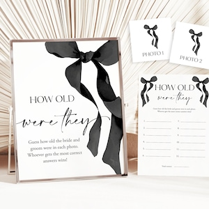 May include: A printable wedding game with black ribbon accents. The game asks guests to guess how old the bride and groom were in two photos. The text reads "How old were they?"