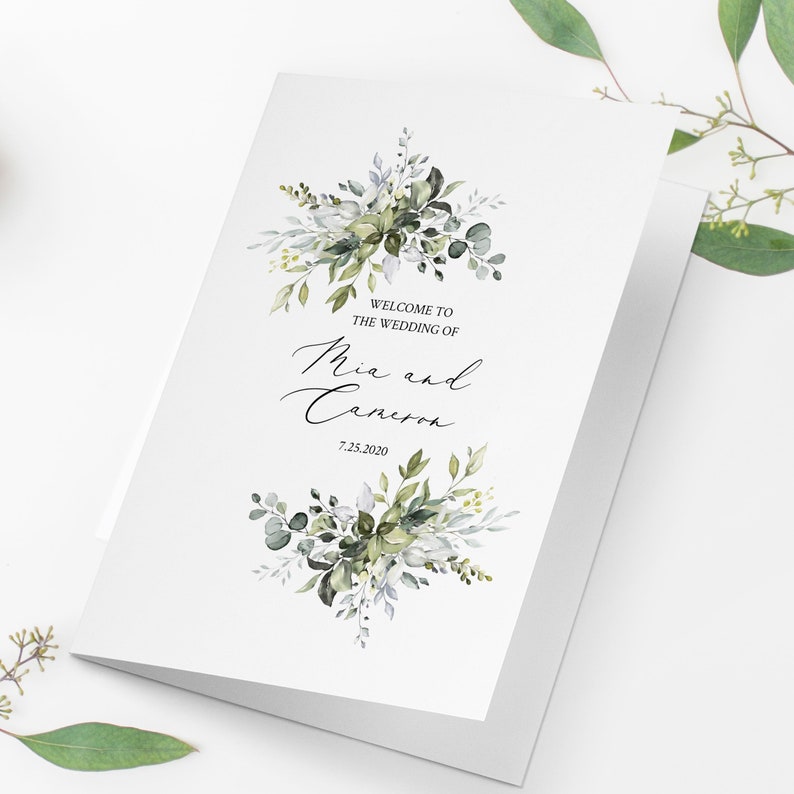 May include: A white wedding invitation with green and white watercolor floral designs. The text reads "Welcome to the wedding of Mia and Cameron 7.25.2020".