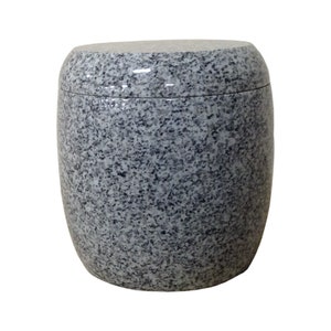 May include: A gray granite urn with a smooth, rounded top. The urn has a speckled pattern throughout.
