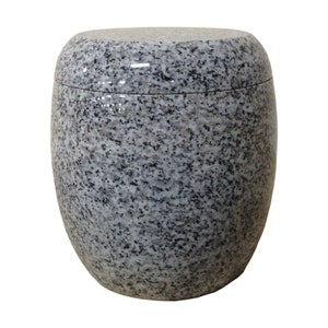 May include: A gray granite urn with a smooth, rounded top. The urn has a speckled pattern throughout.