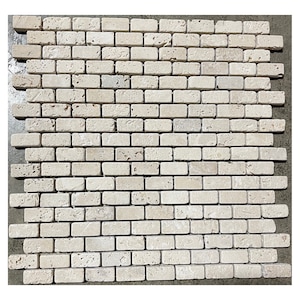 May include: A beige brick mosaic tile sheet with a staggered brick pattern. The tiles are made of natural stone and have a rough, textured surface.