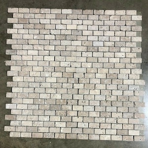 May include: A rectangular mosaic tile sheet composed of small, light beige brick-shaped tiles. The tiles are arranged in a staggered pattern, creating a brick-like appearance. The tiles are mounted on a mesh backing.