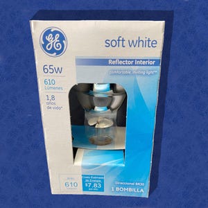 May include: A white box with a GE logo and the text "soft white" on it. The box contains a 65 watt, 610 lumen, BR30 light bulb. The bulb is designed for interior use and has an estimated energy cost of $7.83 per year.
