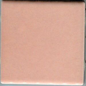May include: A solid pink ceramic tile with a smooth, glossy finish.