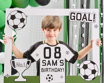 May include: A white photo booth frame with a green and black soccer theme. The frame has a soccer ball, a trophy, and a jersey with the number 08 and the text "Sam's Birthday!" printed on it.