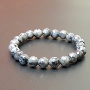 May include: A black and grey beaded bracelet made of labradorite stones.