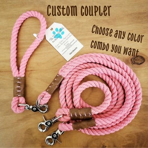 May include: Pink cotton rope dog leash with two clips and brown leather accents. The leash is handmade and says "Custom Coupler" and "Choose any color combo you want".