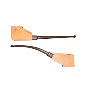 May include: Two smoking pipes with light tan, rectangular-shaped wooden bowls and long, dark brown stems. One pipe features a straight stem, while the other pipe has a curved stem. Both pipes have a distinct, angular design for the bowl section.