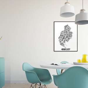 May include: A black and white typography art print of Jersey City, New Jersey. The print features the names of neighborhoods and landmarks within the city, forming the shape of the city.