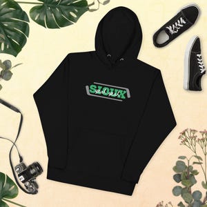 May include: Black hoodie with a green and gray graphic that says "Sioux yeah yeah" on the front.