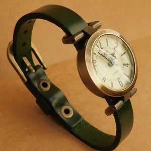 Green leather watch for women. Classic retro style minimalist wristwatch with aged bronze finish.