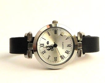 Classic women's wristwatch with black, brown, or red strap.