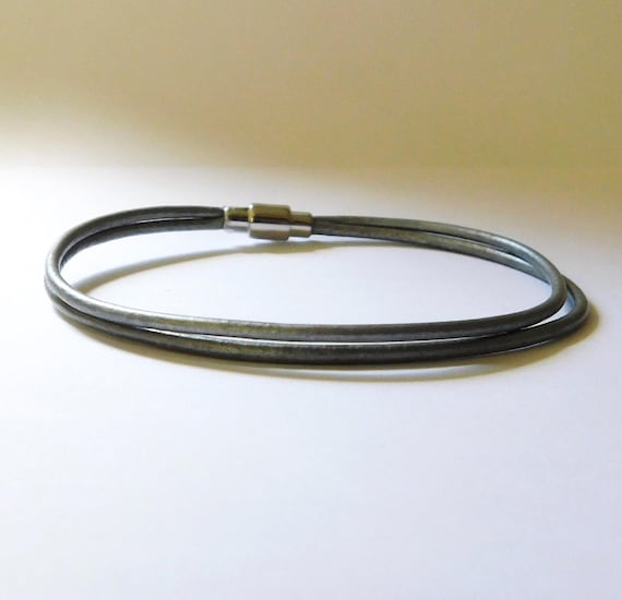 Bracelet, delicate, custom-sized, made with silver leather and a magnetic closure.