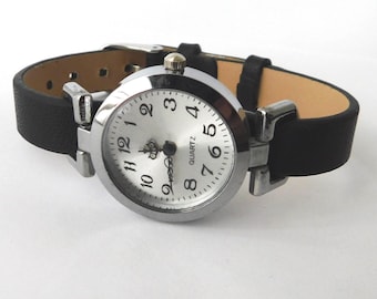 Classic wristwatch for women, silver face, and black adjustable strap.