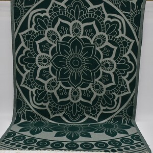May include: A green and white mandala patterned throw blanket with a fringe border.