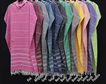 May include: A row of ten hooded towels in various colors, including pink, burgundy, gray, teal, navy, black, green, brown, yellow, salmon, purple, and pistachio. The towels have a striped pattern and fringe trim.