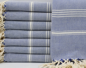 May include: A stack of blue and white striped towels with fringe edges. The towels are made of cotton and are soft and absorbent.