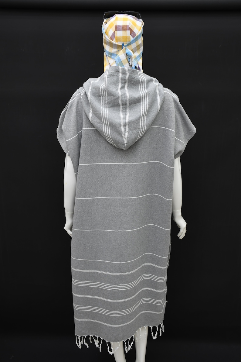 May include: Gray hooded towel with white stripes. The towel has a fringe around the bottom edge.
