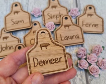 Wooden wedding name place settings in the shape of a cow ear x 70