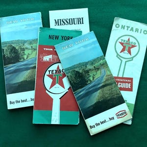May include: Five vintage Texaco road maps, including New York, Missouri, and Ontario. The maps feature a red star with a white "T" in the center, and the text "Buy the best...buy Texaco".