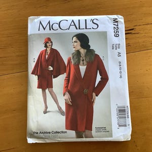 May include: Vintage sewing pattern for a red coat with a fur collar. The pattern is from McCall's and is for sizes 6-8-10-12-14. The pattern is called "The Archive Collection" and is from circa 1927.