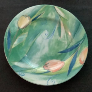 May include: A green and blue ceramic plate with a floral design. The plate features a watercolor-style painting of tulips and leaves.