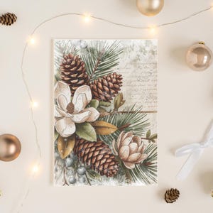 May include: A botanical illustration featuring a magnolia flower, pine cones, and evergreen branches. The artwork has a vintage aesthetic with a soft colour palette of cream, brown, and green. The composition is arranged on a rectangular card.