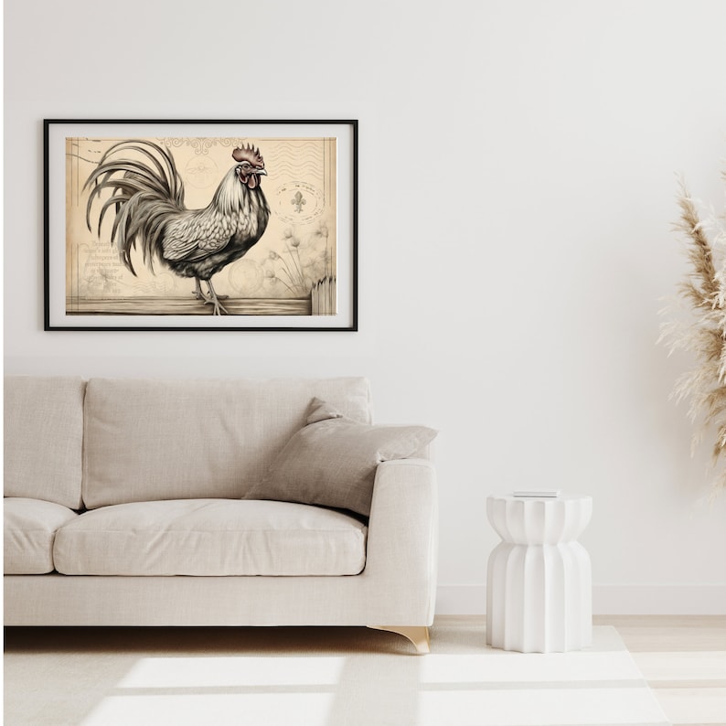 May include: A black and white illustration of a rooster with a red comb and wattle, standing on a wooden fence. The illustration is framed in a black frame and is hanging on a white wall.