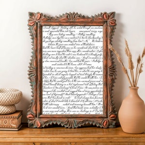 May include: A close-up of a framed piece of art with a handwritten text in black ink. The text is a story about a man named Leo and his relationship with a woman named Catherine. The text is written in a flowing, cursive script.