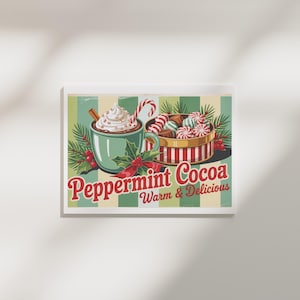 May include: A framed print featuring a vintage-style illustration of peppermint cocoa. A teal mug with whipped cream, a cinnamon stick, and a candy cane sits next to a box of candies. The words "Peppermint Cocoa" and "Warm & Delicious" are displayed.