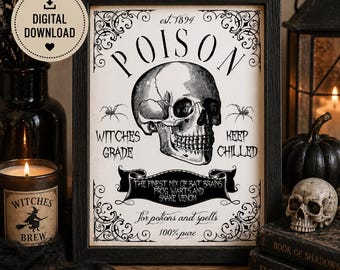 May include: Black framed print with a skull illustration and the word "POISON" at the top. The print includes text such as "Witches Grade" and "Keep Chilled". A candle and a small skull are also visible.