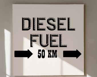 May include: Black and white sign with the text "DIESEL FUEL 50 KM" and two black arrows pointing in opposite directions.