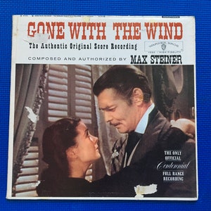 May include: Vintage vinyl record album cover for "Gone With The Wind," featuring a black and white image of two people looking at each other. The album cover has the text "GONE WITH THE WIND" and "The Authentic Original Score Recording."