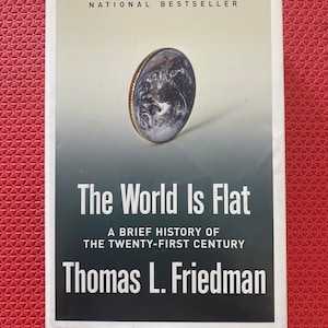 May include: A book titled "The World Is Flat" by Thomas L. Friedman. The cover features a coin with an image of Earth. The text "NATIONAL BESTSELLER" is at the top. The book's title and author's name are in white text on a dark background.
