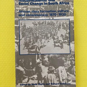 May include: A book titled "Industrialisation and Social Change in South Africa" with the subtitle "African class formation, culture and consciousness 1870-1930." The cover features a grayscale image of a crowd of people. Edited by Shula Marks and Richard Rathbone.