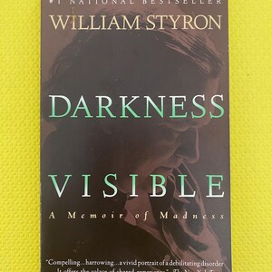May include: A book cover for "Darkness Visible: A Memoir of Madness" by William Styron. The cover features a dark background with the title in large, white and green letters. The author's name is in gold, and the book is a #1 National Bestseller.